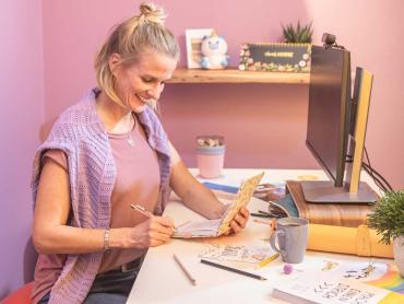 Frau sitzt an Schreibtisch