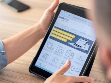 Frau hält Tablet mit Smartpro eProcurement-Lösung