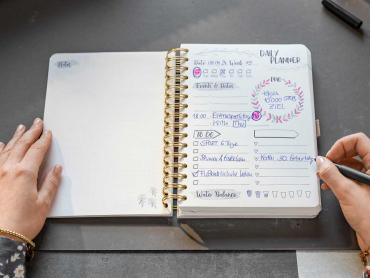 Frau schreibt in undatierten Kalender