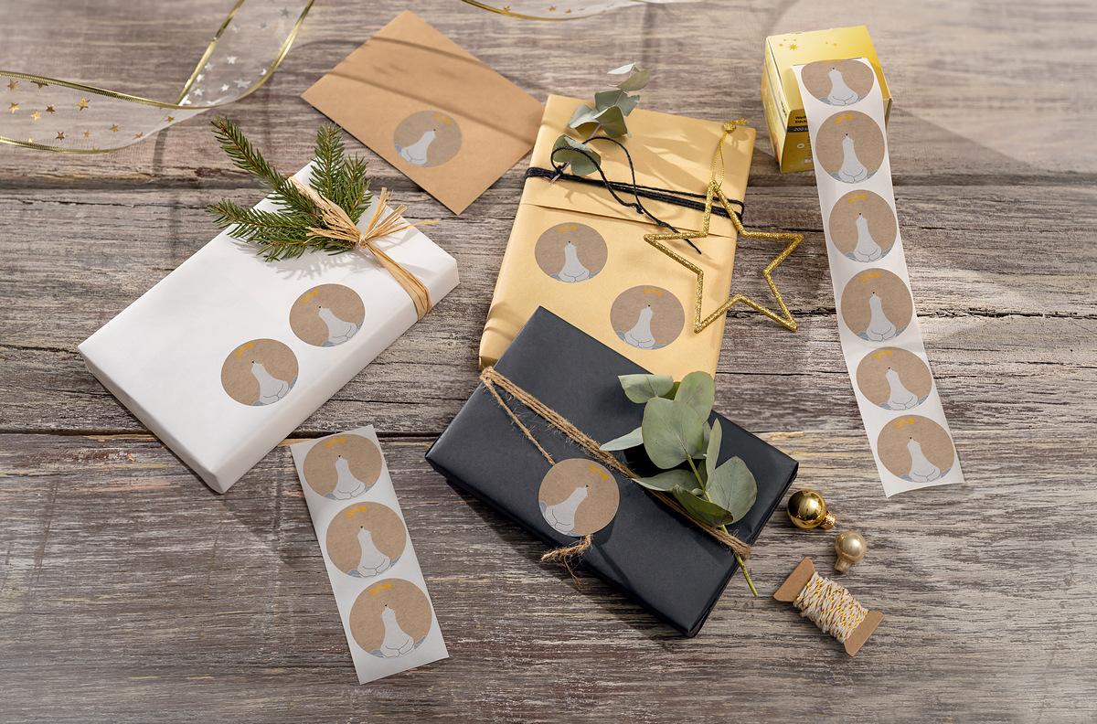 Gift packaging with bird stickers decorated with twigs and golden balls