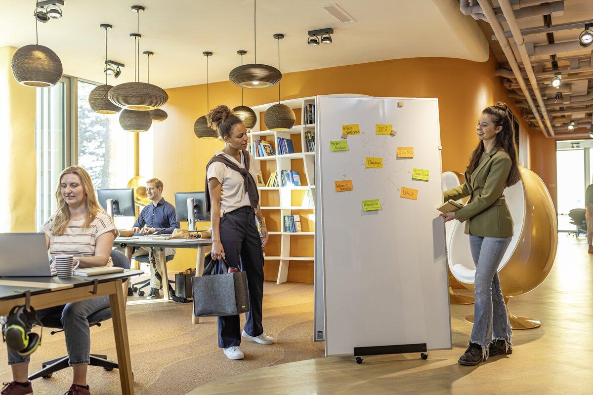 Office with four people, whiteboard