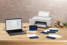 Laptop and printer on wooden table, Christmas cards