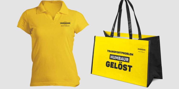 T-Shirt und Tragetasche in gelb mit Logo von Humbaur