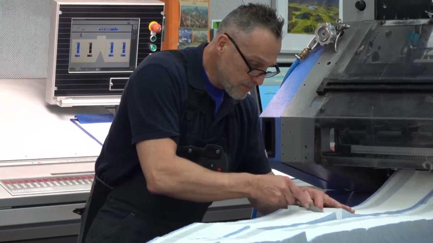 Drucker arbeitet an Druckmaschine